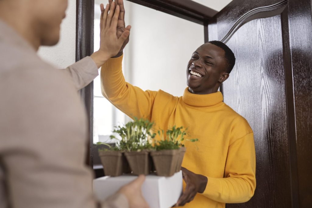 Kenyan Host welcoming a guest into his property. List your property online in Kenya.